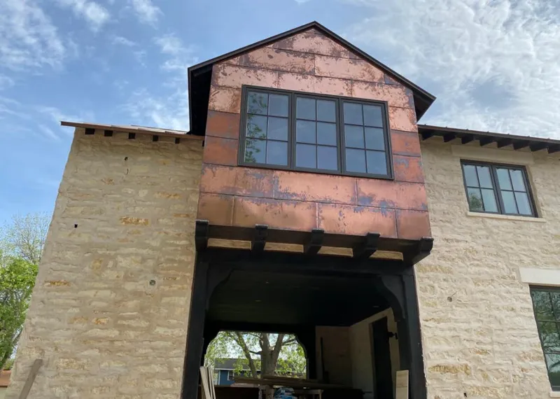 Copper metal panel facade on a stone building for Skylight Installation in Dedham